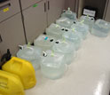 Photo showing plastic containers filled with seawater from the central Pacific ocean.