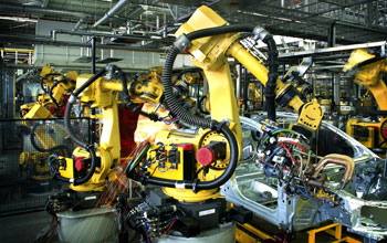 Photo of robots at work on assembly line in a car factory