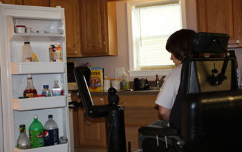 Photo of a person with disabilities getting help from a remote human assistant.