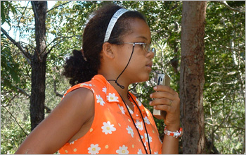 Mara Fonseca, 13 years old, recording observations of the monkeys' behavior