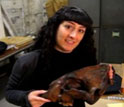 paleontologist Julie Meachen holding the skull of an extinct saber-toothed cat.