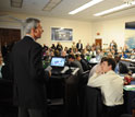 Representative Daniel Lipinski speaking in front of a standing-room-only crowd.