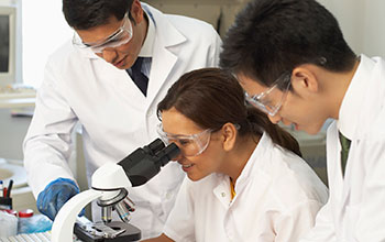 Photo of three scientists working in a laboratory.