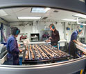 Photo of scientists using laboratories aboard the JOIDES Resolution to analyze expedition samples.