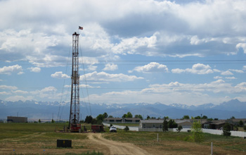 Photo of a workover rig completing a well near a surburban development in Weld County, Colo.