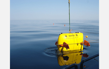 AUV <em>Sentry</em> is lowered into the water from RV <em>Oceanus</em> for first dive