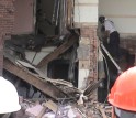 Researchers watch as an Indiana Task Force member enters the partially collapsed building.