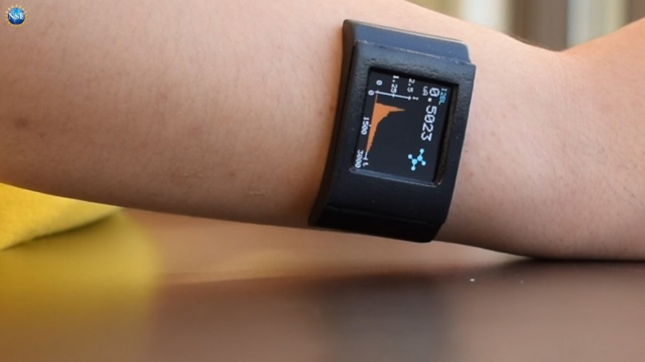 a smart watch on a person's wrist displaying a graph