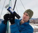 a researcher setting up the equipment to measure how much snow and the crystal type.