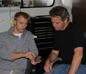 Photo: Scientists Noah Plavansky and Tim Lyons discuss attributes of a banded iron formation sample.