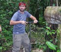 Researcher Jake Schiferl uses a soil augur to extract samples from the flood-plain forest of Peru.