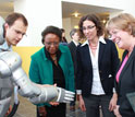 Photo of Cora Marrett, Dahlia Sokolov and Joan Ferrini-Mundy interact with humanoid robot.