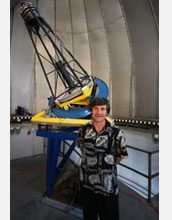 Alex Filippenko smiling in front of the Katzman Automatic Imaging Telescope