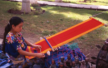Photo of woman from Guatemala making a textile.
