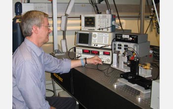 Photo of William Stillman in the lab evaluating the effects of focused terahertz radiation.