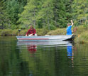 Photo of Tim Cline on the left and Lee Zinn on the right in a boat sampling minnows.