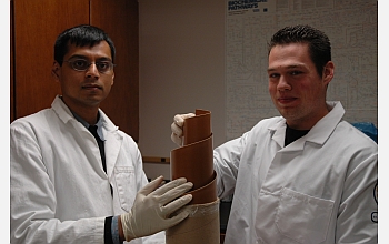 Researchers hold the polymer that is critical to their water filtration system.