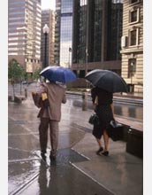 People holding umbrellas in rainy weather.