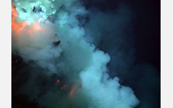 Photo of an eruptive blast at West Mata Volcano, with superheated pillow lava flowing downslope.