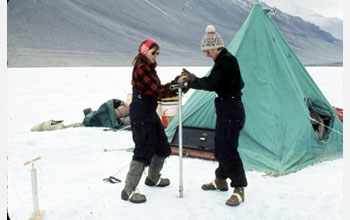 Photo of women geoscientists using a hand augur to drill Lake Vanda, Antarctica, in 1969-1970.