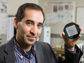 Masoud Agah is holding up a microelectrode array