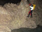 cave explorer climbs the wall