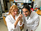 Erika Geisbrecht studies a vial with a student