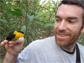 Matthew Fuxjager with a golden-collared manakin