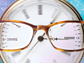 eye glasses on top of a watch