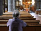 a person sitting in a church pew
