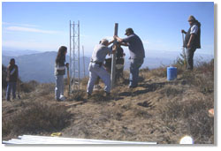 Installation of a solar-powered wireless network relay station; caption is below