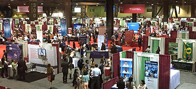 [A large exhibit hall with the NSF exhibit booth at its center at the annual SACNAS meeting in California]