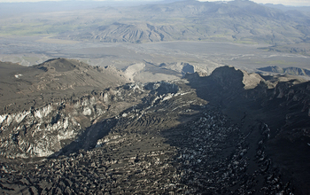 An empty lagoon, where a glacial dam burst during the eruption, is at the glacier's lower end.