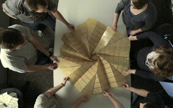 Poeple at a table creating origami