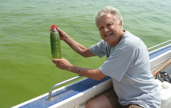 Scientist Hans Paerl holding a bottle with algae in water from in Lake Taihu.
