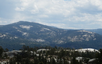 mountain with patchy forest cover,