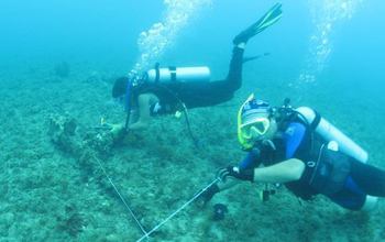 Lillian Asevedo and James Hewitt record an anchor under water