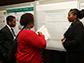 Students explaining a poster.