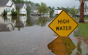 Flooded area with high water sign