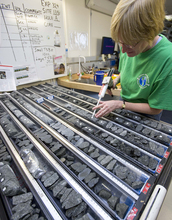 A researcher on a previous IODP expedition labels pieces of core collected while at sea.