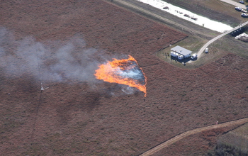 The experimental grass fire spreads through instrumentation placed in a research plot.