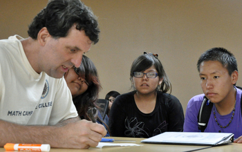 Kansas State University David Auckly works with students at a summer math camp.