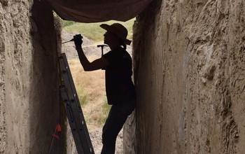 Naomi Ward, University of Wyoming associate professor of molecular biology, collects soil samples for microbiome analysis at the LaPrele Creek mammoth kill site near Douglas, Wyoming.