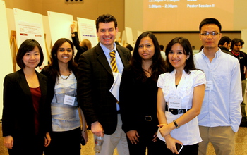 professor with graduate students at conference