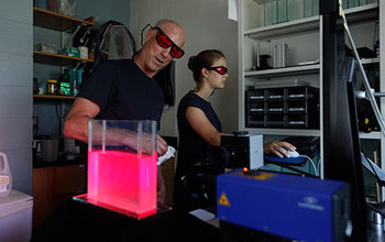 Jack Costello and a colleague conduct research on siphonophores in the laboratory.
