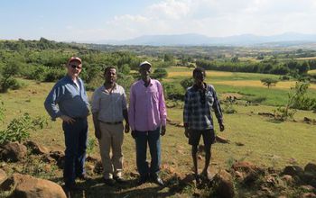 Seifu Tilahun stands with community farmers and a USAID representative in Ethiopia