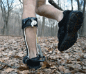 animated gif showing a man walking in the park wearing a passive-elastic ankle exoskeleton