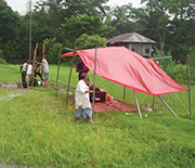 Drilling a shallow well in Bangladesh, with collection of drill cuttings every five feet.