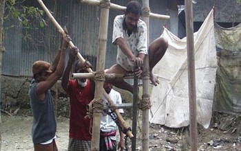 Close-up of team drilling a shallow well in Bangladesh.