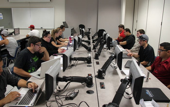 students at computers in cybersecurity program